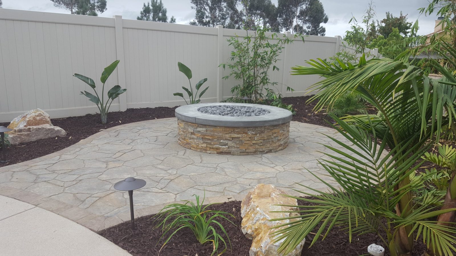 Path lights around a flagstone patio and stacked-stone fire pit, Carmel Valley, San Diego