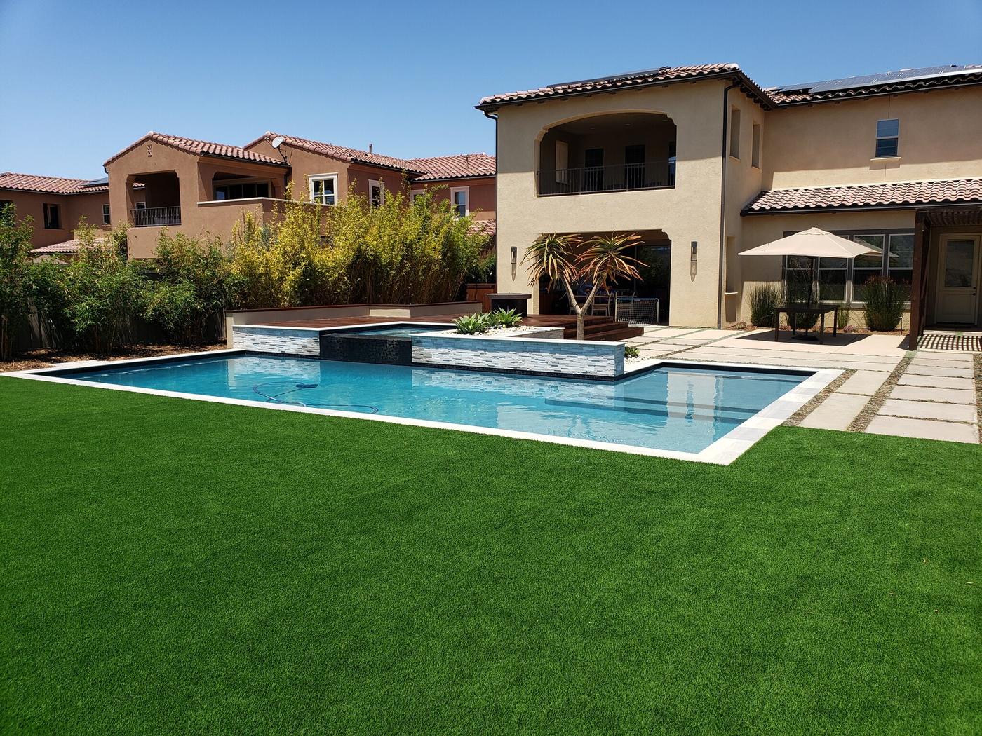 Pool with spa and synthetic lawn
