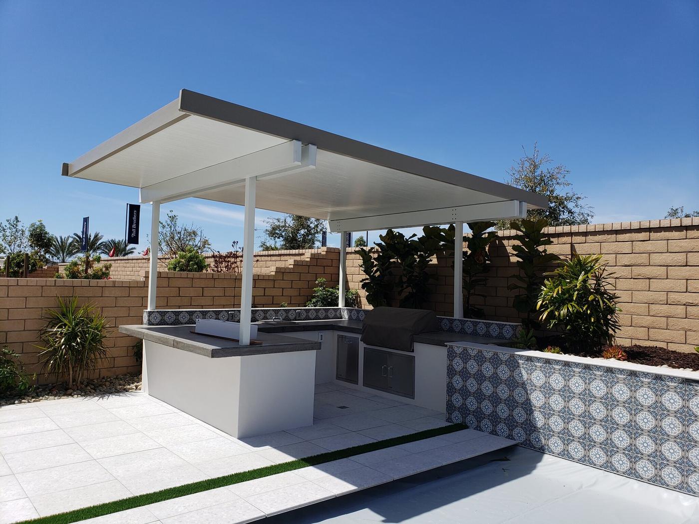 Aluminum patio cover over a tiled BBQ island